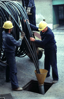 Laying optical fibers in telephone ducts of Turin (Italy)